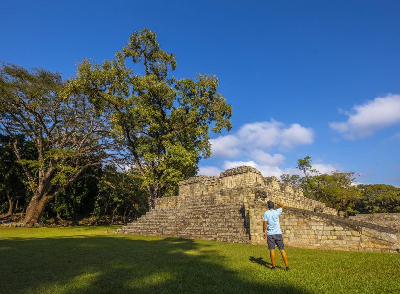 Beautiful shot of a tourist visiting Copan Ruinas and its beautiful Mayan ruins in Honduras Beautiful shot of a tourist visiting Copan Ruinas and its beautiful Mayan ruins in Honduras