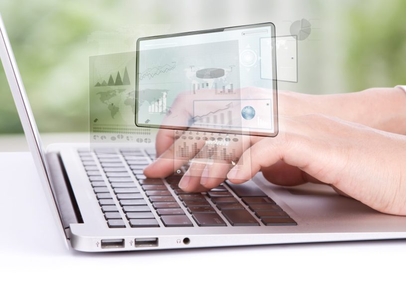 Closeup of business woman hand typing on laptop keyboard